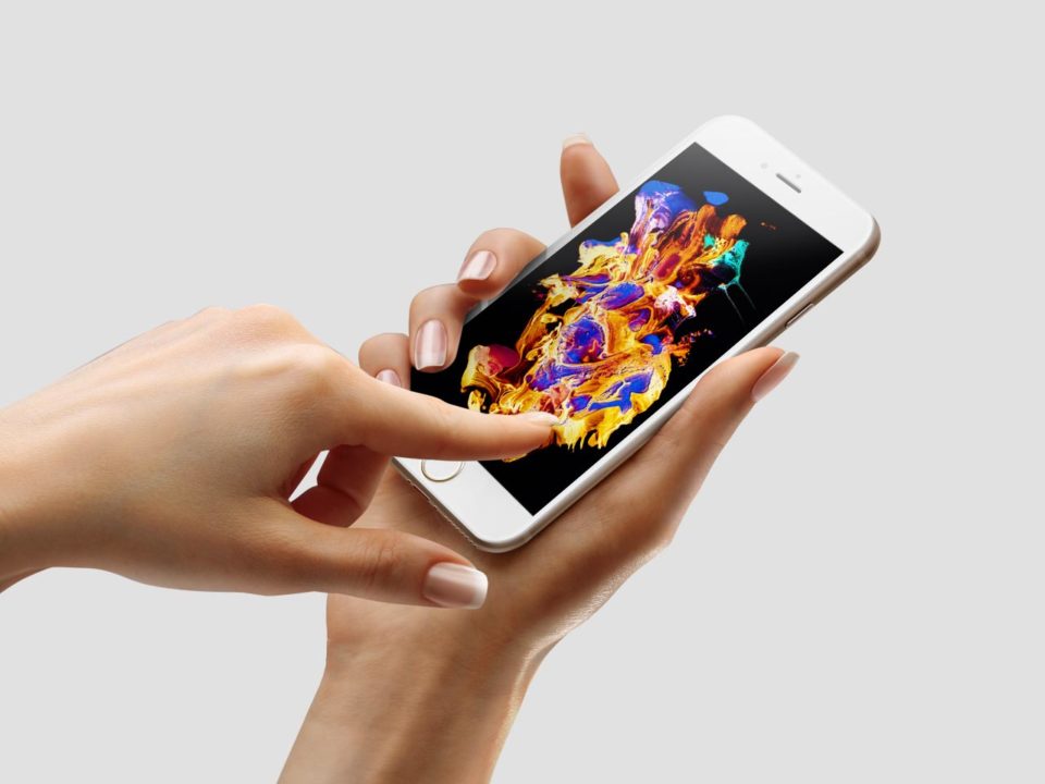Person using smartphone with colorful display.