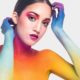Colorful artistic makeup on model's face.