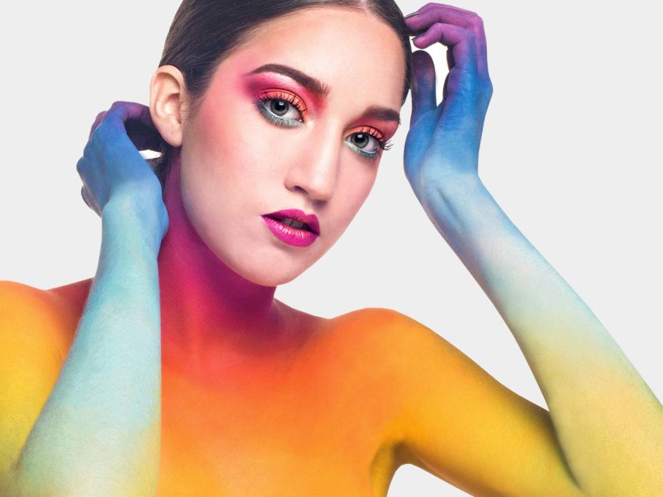 Colorful artistic makeup on model's face.
